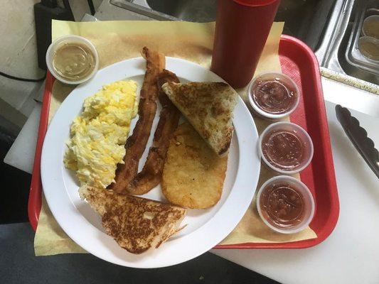 3 Freshly Scrambled Eggs (Or cooked your way), Bacon, Hash Brown, Sour Dough Toast.