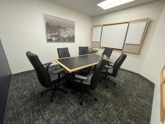 Our small conference room holds 6 people with a flat screen TV and whiteboard with tear away sheets. Includes Wi-Fi and refreshments.