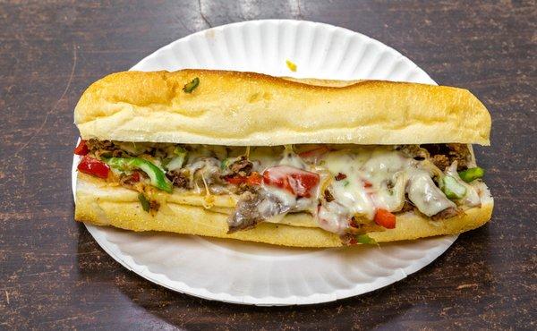 Philly Cheesesteak (chopped steak, melted cheese, peppers and onions on a hero)