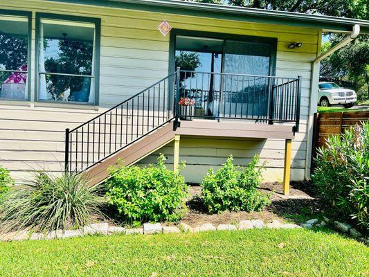 Small composite patio with iron railing