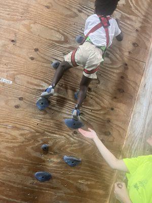 Son on rock climbing wall