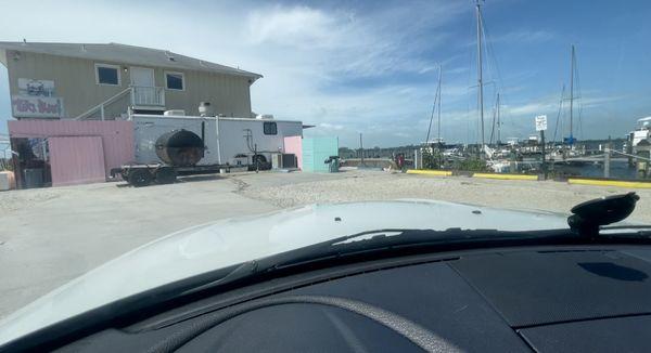 Gravel lot near docks with restaurant only parking signs and no clearly marked handicapped spots