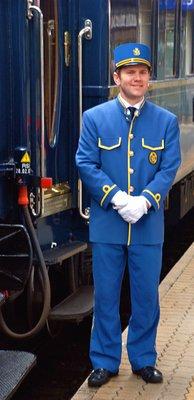 Jake, a steward who hails from New Zealand, stands outside a vintage, coal-heated Venice Simplon-Orient-Express sleeping car....