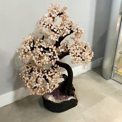 Our highest ticket item, a beautiful Rose Quartz tree with over 1,000 crystal leaves sitting on an Amethyst base.