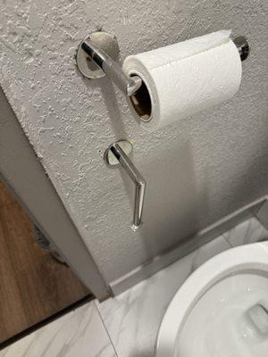 Broken toilet paper holder.