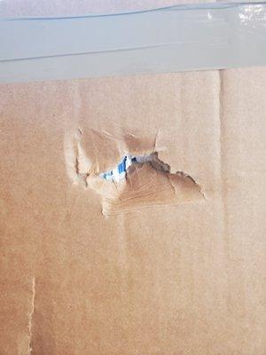 A painting that was wrapped by movers in thick cardboard and plastic and marked fragile was punctured through all the layers through to back