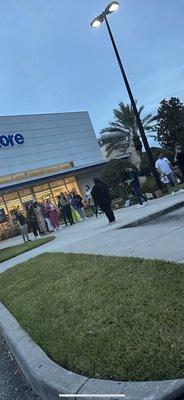 Staff outside while their doors are shut during store hours.