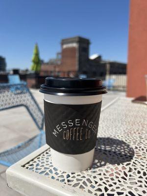 Soy latte 12 oz on the patio table