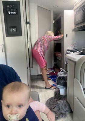 The horror of my 80 YO MOM having to hold the fridge closed -it opens repeatedly. See towels on floor for water pouring inside RV when movin