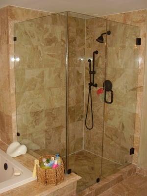 Frameless shower enclosure