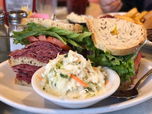 Corned beef and tongue sandwich with a delicious side of coleslaw