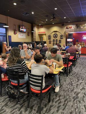 Dining area, more booths and tables and self served fountain drinks area with utensils.