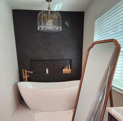 Beautiful Bathroom with custom wall with insert, deep bath tub.