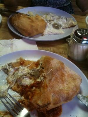 Two half eaten meatball and garlic calzones. These are incredible!