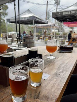 Outdoor picnic tables on the asphalt parking lot in the cold rain with no heaters.  Beer was okay.