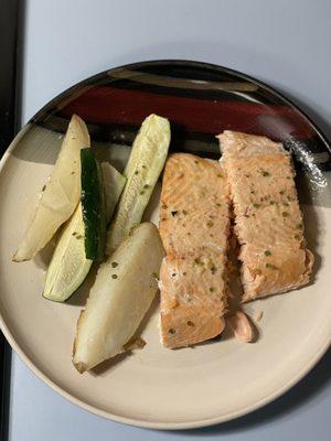 Fresh baked salmon in garlic lemon butter sauce with potato and zucchini