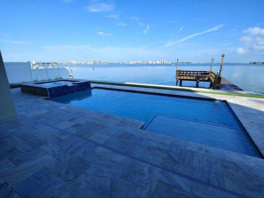 Waterfront Residential Pool with Spill-Over Spa