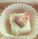 A Pistachio aboard a White Chocolate and Rose Cream