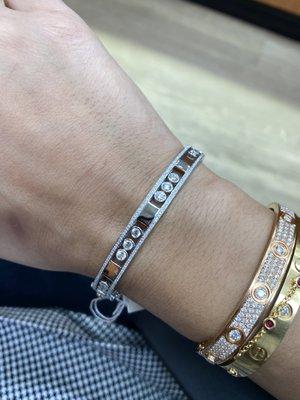 The "dancing" diamond bangle has a split hinge, double safety clasps. Works flawlessly!