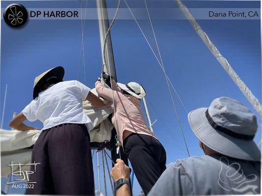 Preparing to make way; attaching the main halyard. (Aventura Sailing - Learn to sail!)