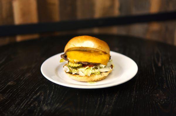 Cheapsburger: Same great burger, just a bit smaller. Cheddar cheese, lettuce, tomato, onion, pickle, and pub sauce on a spent grain bun.