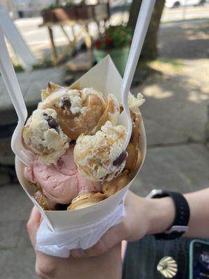 Bubble waffle cone with salted caramel pretzel and strawberry ice cream