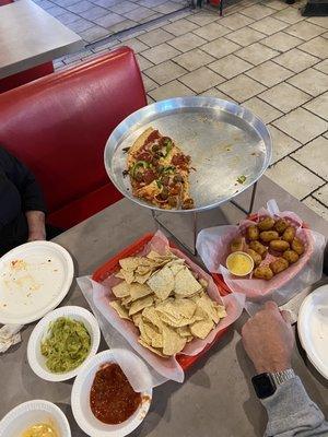 Thin crust pizza, mini corn dogs, chips with salsa, queso, and guac.