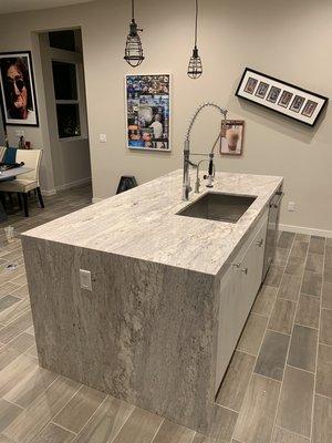 Granite countertop with waterfall on both sides.