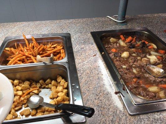 Seasoned fries, fried cubed potatoes, and beef stew