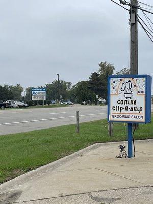 Parking lot sign and visual of where we are located