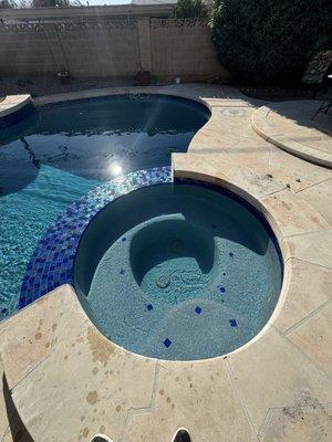 Recently remodeled pool with a new glass tile spillway