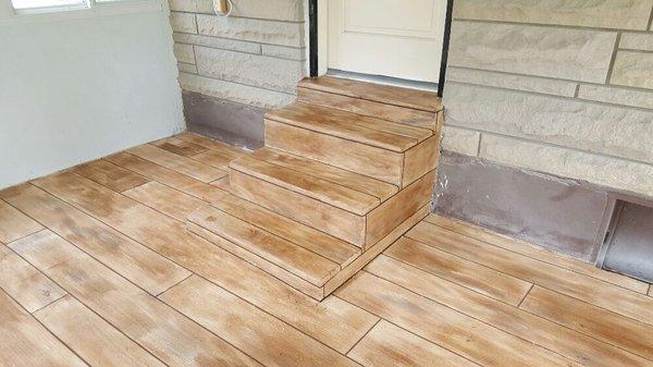 Polymer cement wood plank system for a patio.