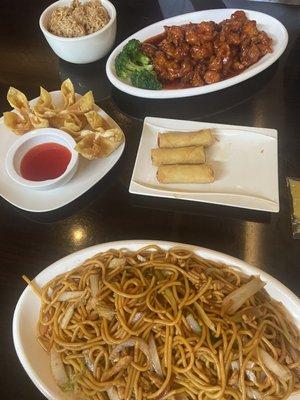 Chicken lo mein, orange chicken and fried rice, crab Rangoon and vegetable rolls