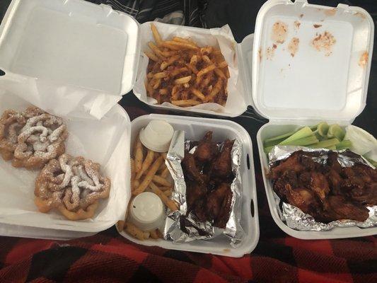 Bacon cheese fries, bbq wings with celery, honey bbq wings with fries and funnel cakes.