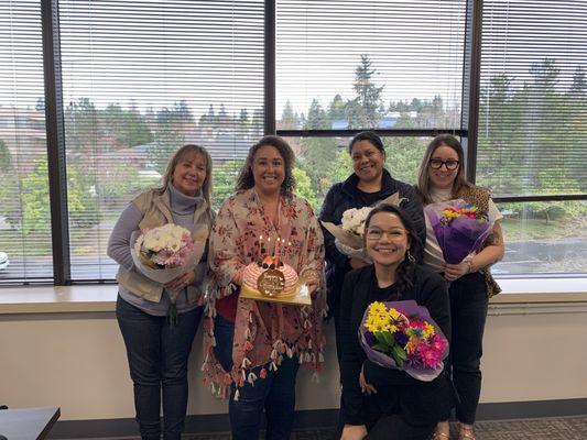 5 Fedelta employees smile as the team celebrates their birthday at the office