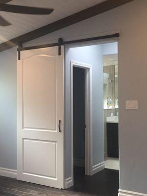 Barn door to vaster bathroom and closets