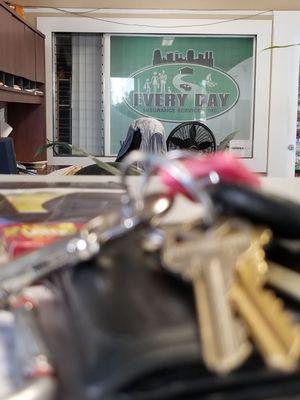 In the office sitting at the counter,  my keys and their logo in the background