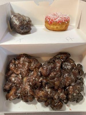 Blueberry cake, peach/apple fritter and a cherry coconut donut.