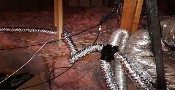 Exhaust vents tied together by electrical tape, vent at a T so exhaust from one bathroom blow into another.