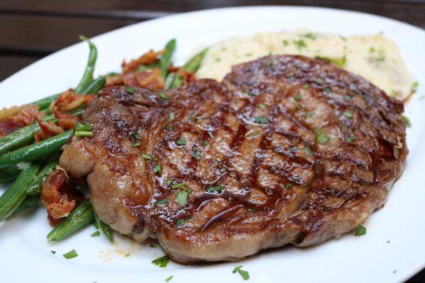 12oz Ribeye steak, creamy mashed potatoes and green beans with bacon