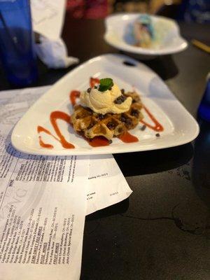 Chocolate chip Belgian waffle with a scoop of ice cream on top