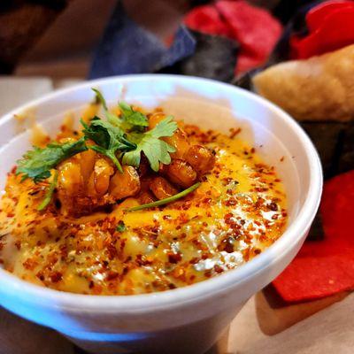 Street corn dip - roasted corn, hatch chile, queso, cotija, cilantro, Tajin, chips