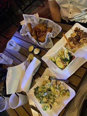 Fried cod basket with sweet potato fries, grilled shrimp with veggies and Caesar salad