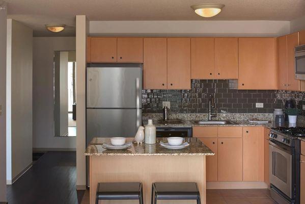 Kitchens with stainless steel appliances. | Aqua at Lakeshore East