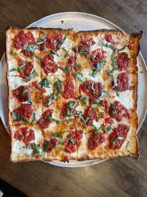 Grandma Pizza with chunk tomato sauce, fresh mozzarella, garlic & basil