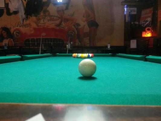 Shooting pool.