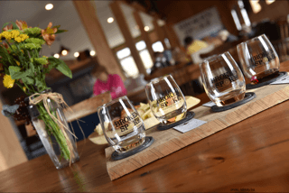 Our typical wine tasting flight is presented on a board with a horseshoe hugging each of the four wines for tasting.