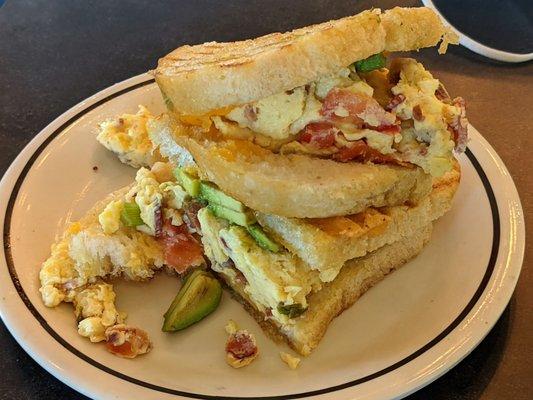 Egg and bacon with avocado panini