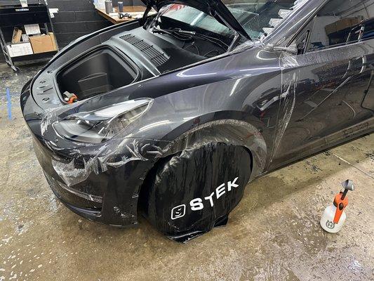 Stek Dynoshield premium PPF being applied to this Tesla Model Y.