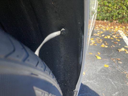 Paint overspray in passenger side front fender.